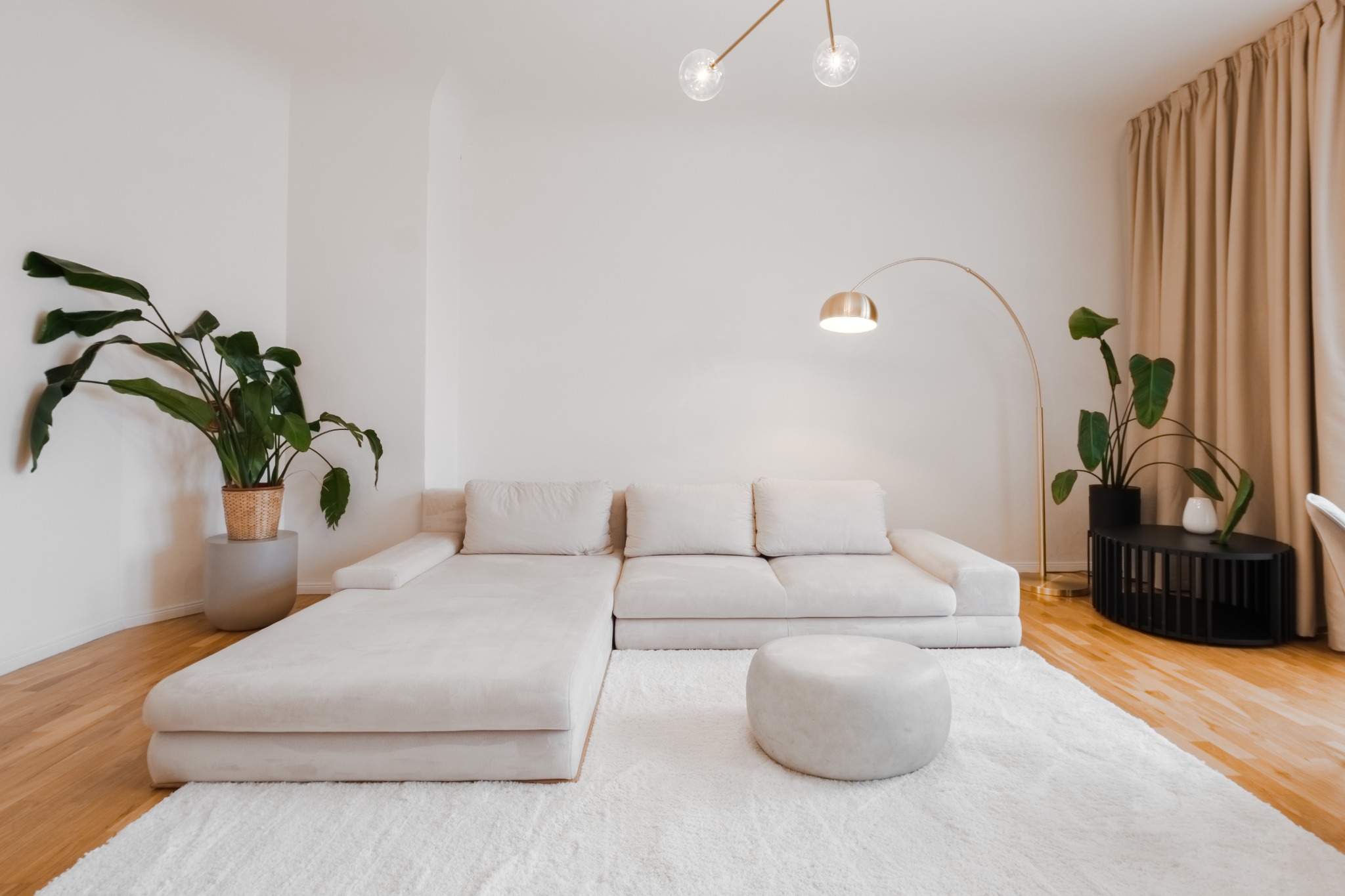 Warm, spacious living room with sculptural lighting